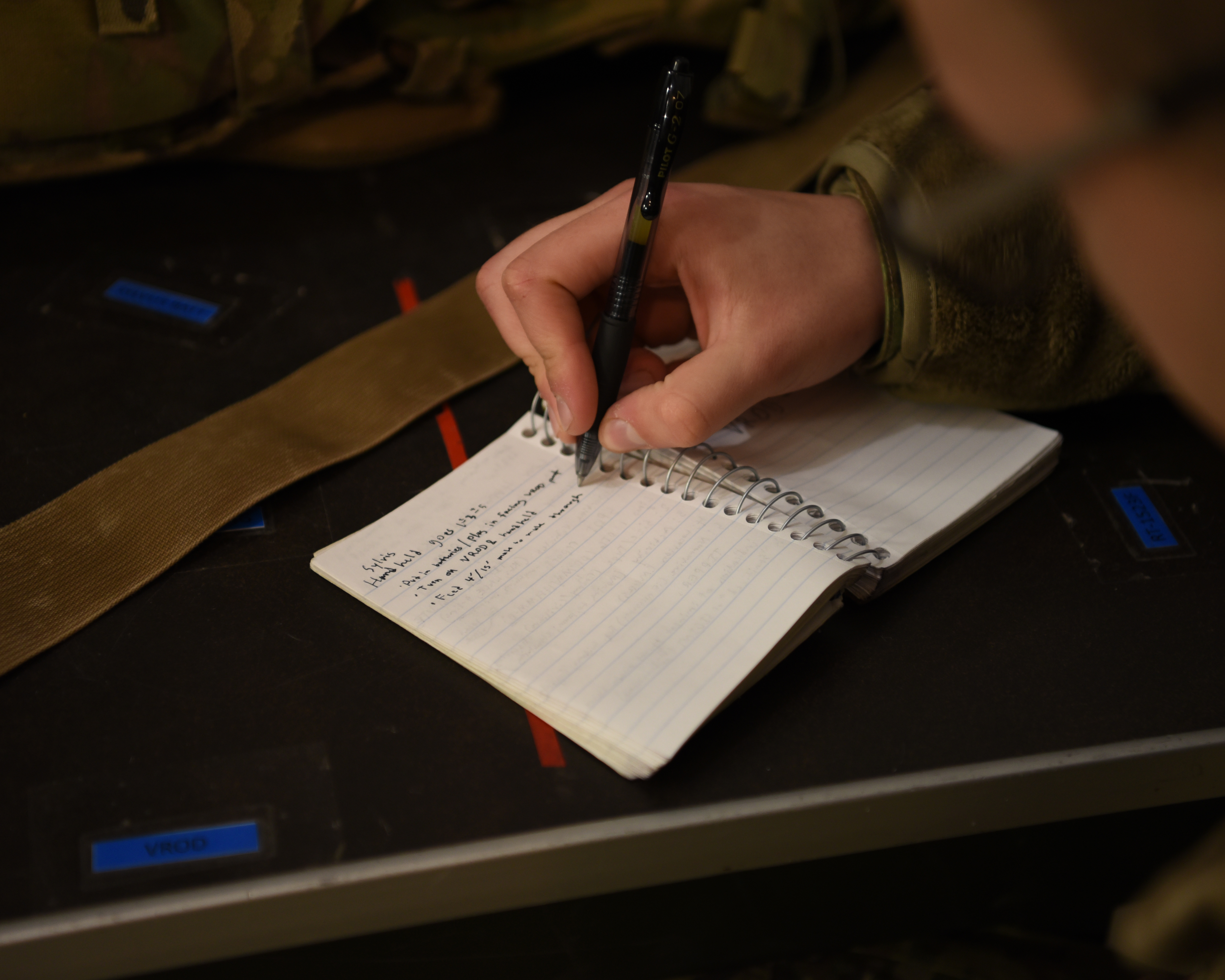 Airman taking notes in a notebook